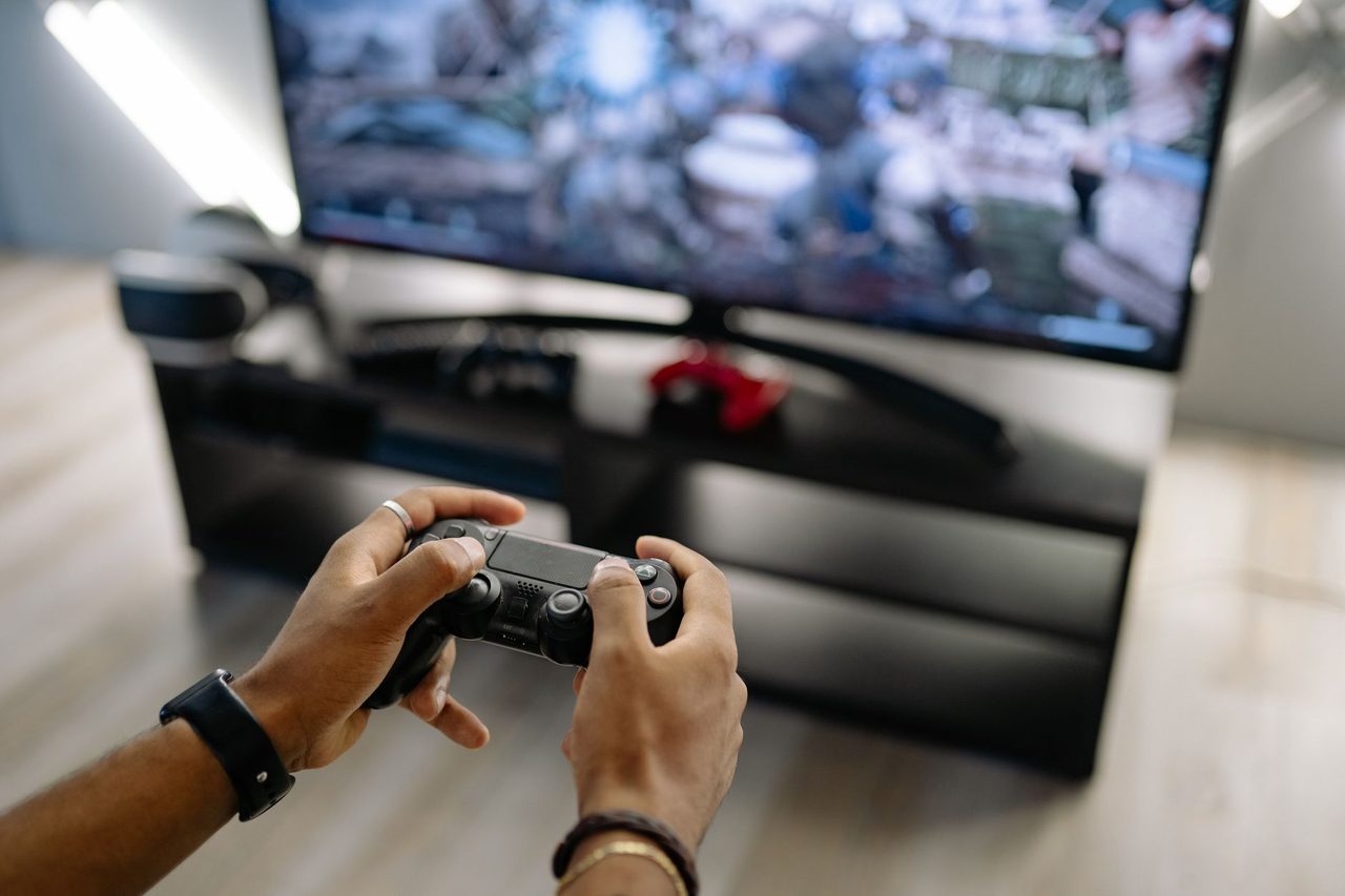Manette en main devant un écran allumé